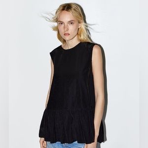 Peplum dotted sleeveless top.